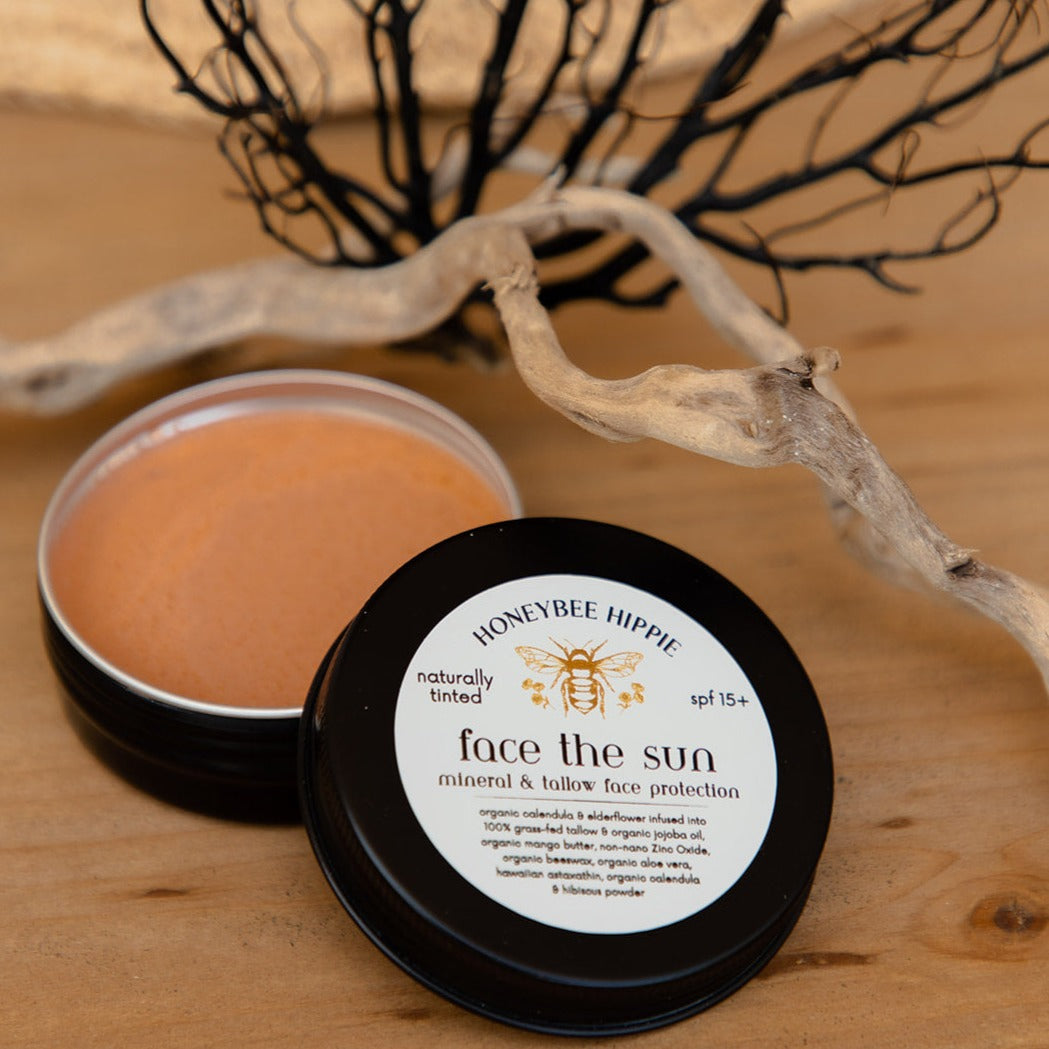 an open tin of natural facial mineral sunscreen handmade with organic tallow by honeybee hippie