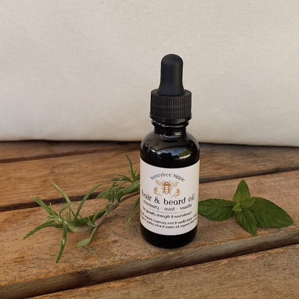a sealed bottle of organic hair and beard oil developed to increase growth and strength of hair with natural oils by honeybee hippie