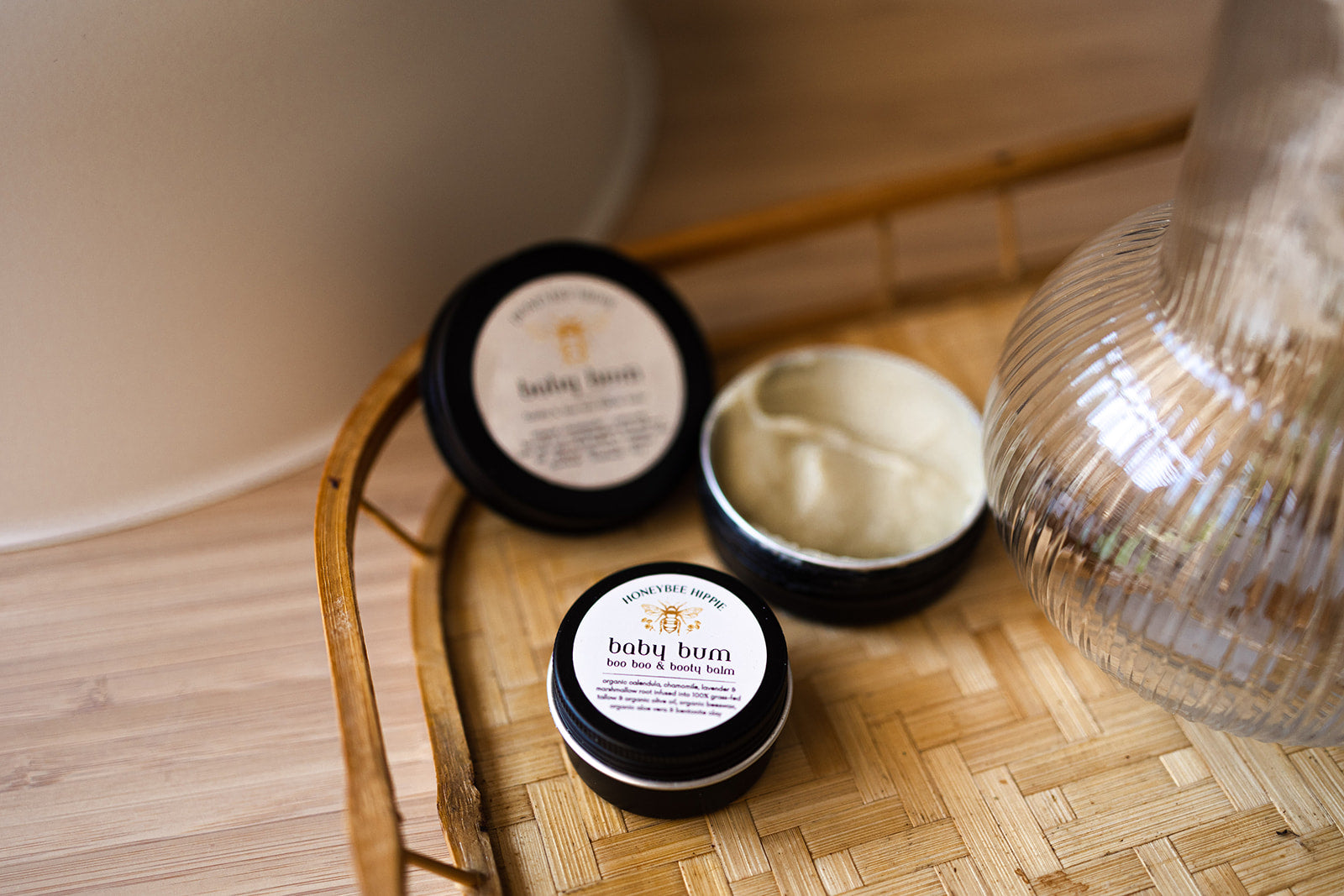 open and sealed tins of safe moisturizer for babies made with organic tallow and oils by honeybee hippie