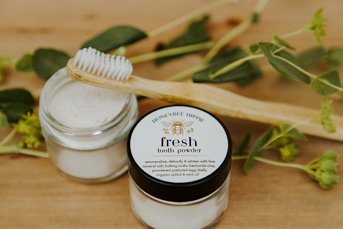 jars of fresh tooth powder developed by honeybee hippie to whiten teeth with natural ingredients