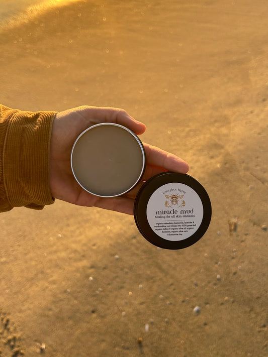a top down view of miracle mud open tin made by honeybee hippie from all natural organic ingredients