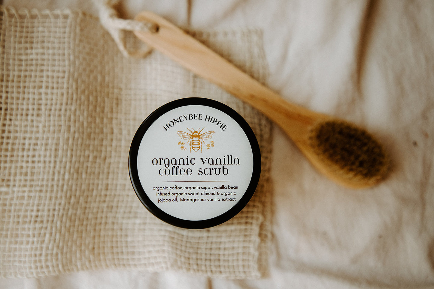 a close of up the label on honeybee hippie's organic vanilla natural body scrub made to exfoliate and hydrate skin with natural organic ingredients