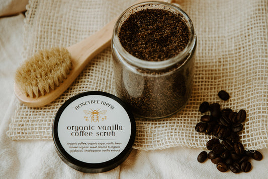 an open jar of organic coffee body scrub to wake up skin with natural ingredients and vanilla to soothe created by honeybee hippie